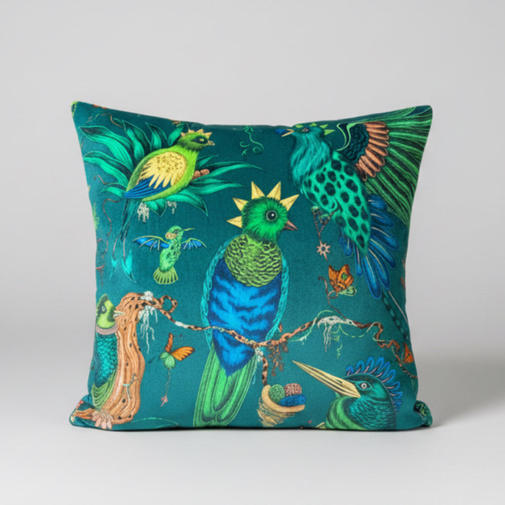 Decorative pillow with colorful bird design on a pink background Emma j shipley