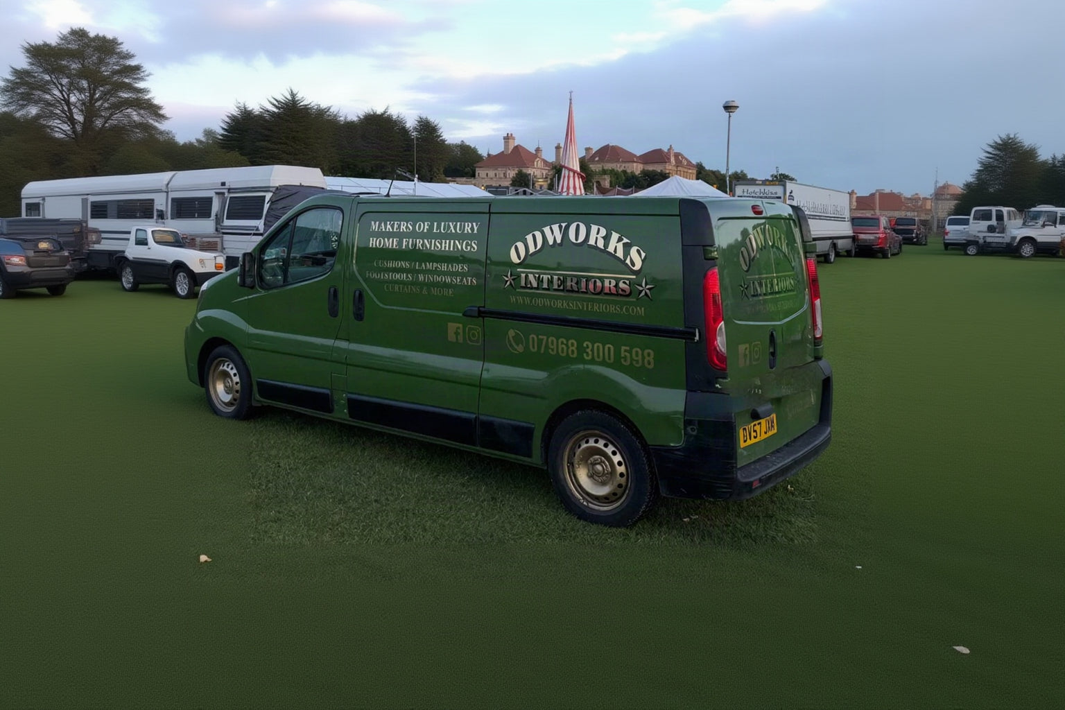 A dark green van parked on grass at Chatsworth House Country Fair 2005 event, featuring custom printed advertising for 'Odworks Interiors' with gold lettering and website details.