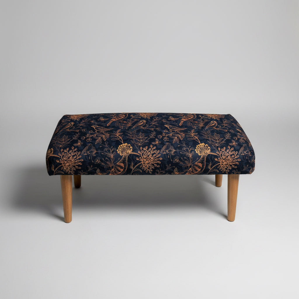 Bench with floral patterned cushion on a concrete floor