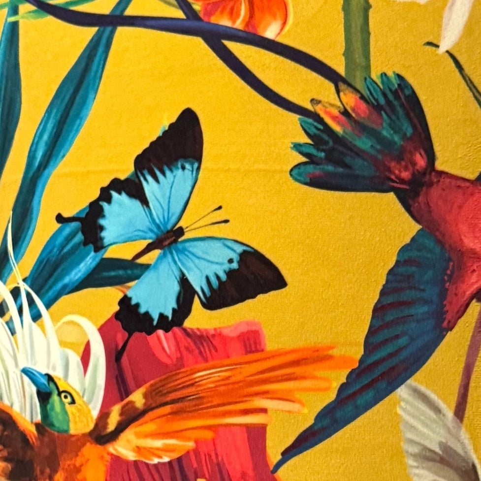 Lamp with a colorful bird and butterfly design on a yellow background