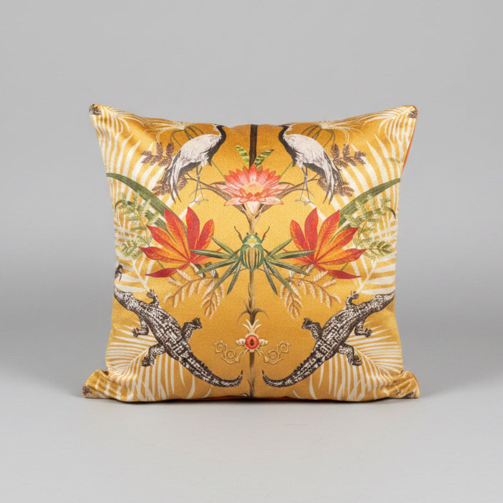 A sunset yellow velvet cushion with a crocodile pattern, placed on a blue velvet chair with a zebra-like pattern on the seat.